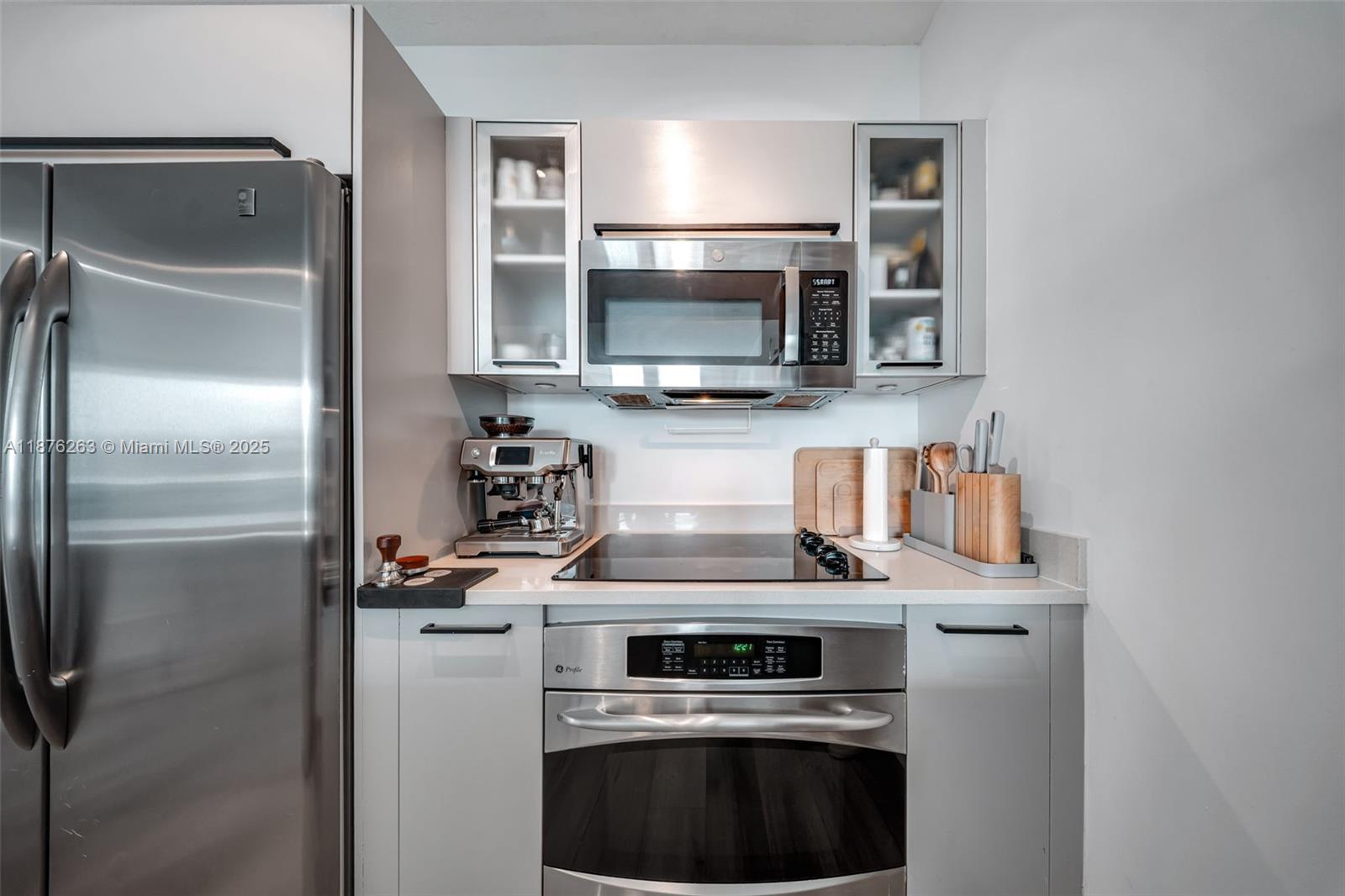 333 Northeast 24th Street, Unit 1111 Miami, FL 33137 - Photo 15 of 39 a kitchen with stainless steel appliances a stove a microwave and a refrigerator