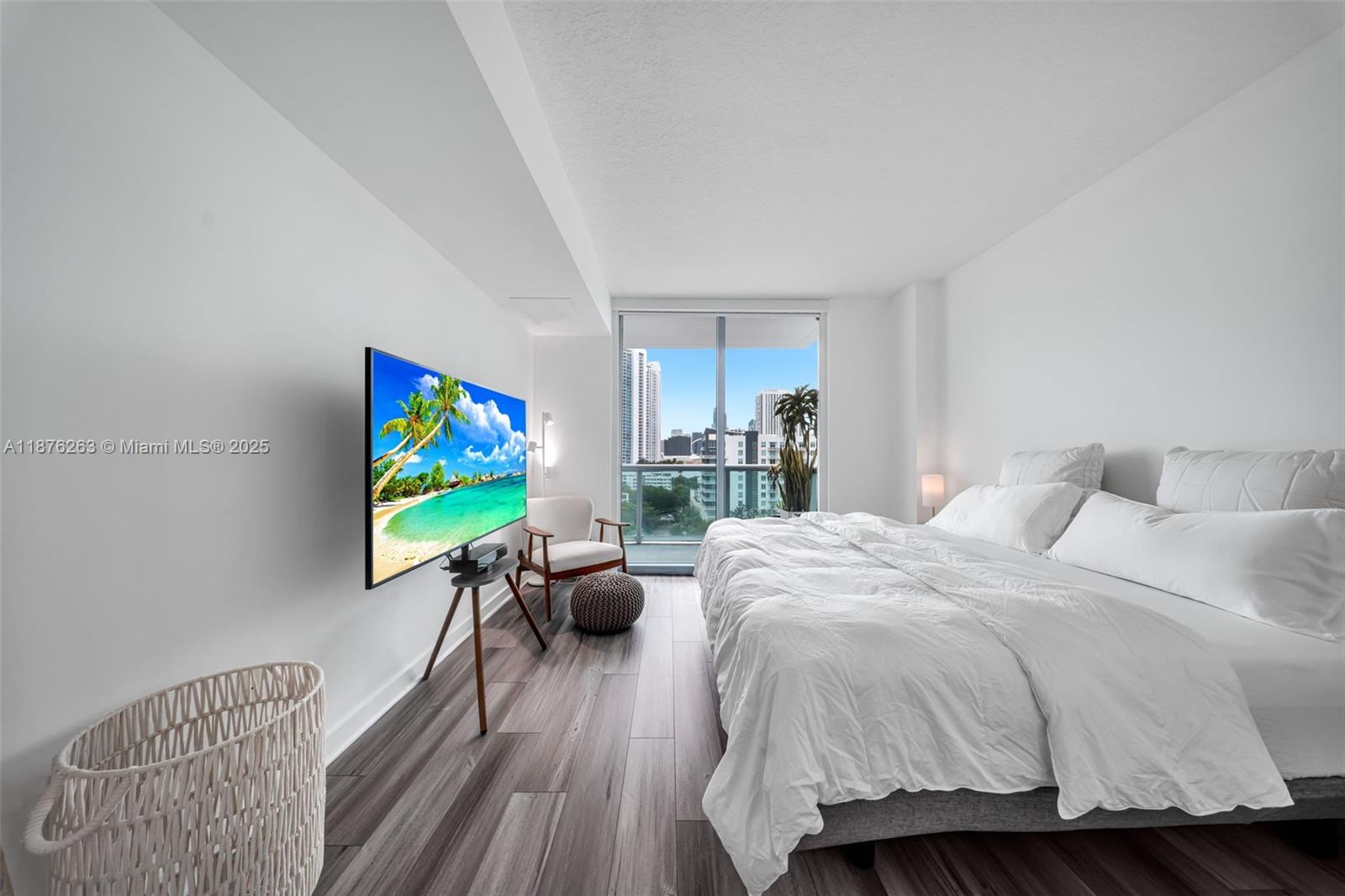 333 Northeast 24th Street, Unit 1111 Miami, FL 33137 - Photo 18 of 39 a bedroom with a bed and a flat screen tv