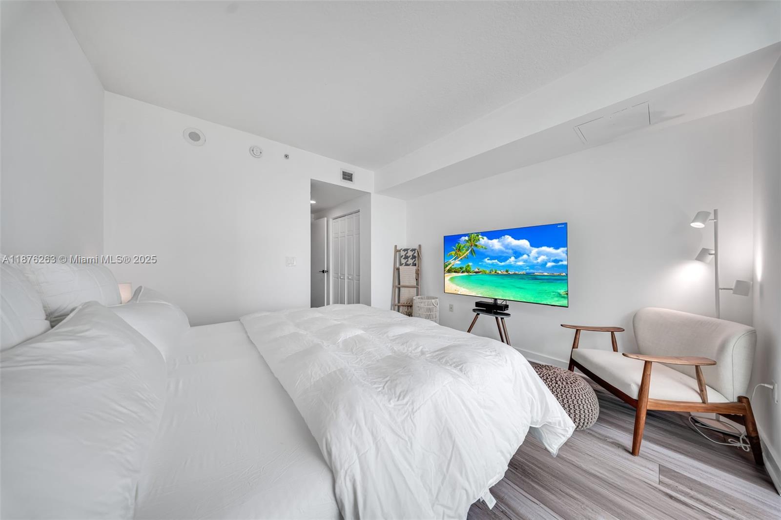 333 Northeast 24th Street, Unit 1111 Miami, FL 33137 - Photo 19 of 39 a bed room with a bed a chair and a flat screen tv