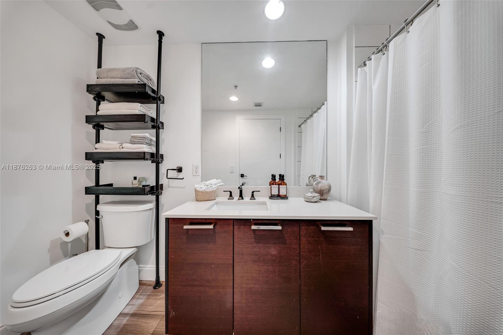 333 Northeast 24th Street, Unit 1111 Miami, FL 33137 - Photo 23 of 39 a bathroom with a sink a toilet and shower