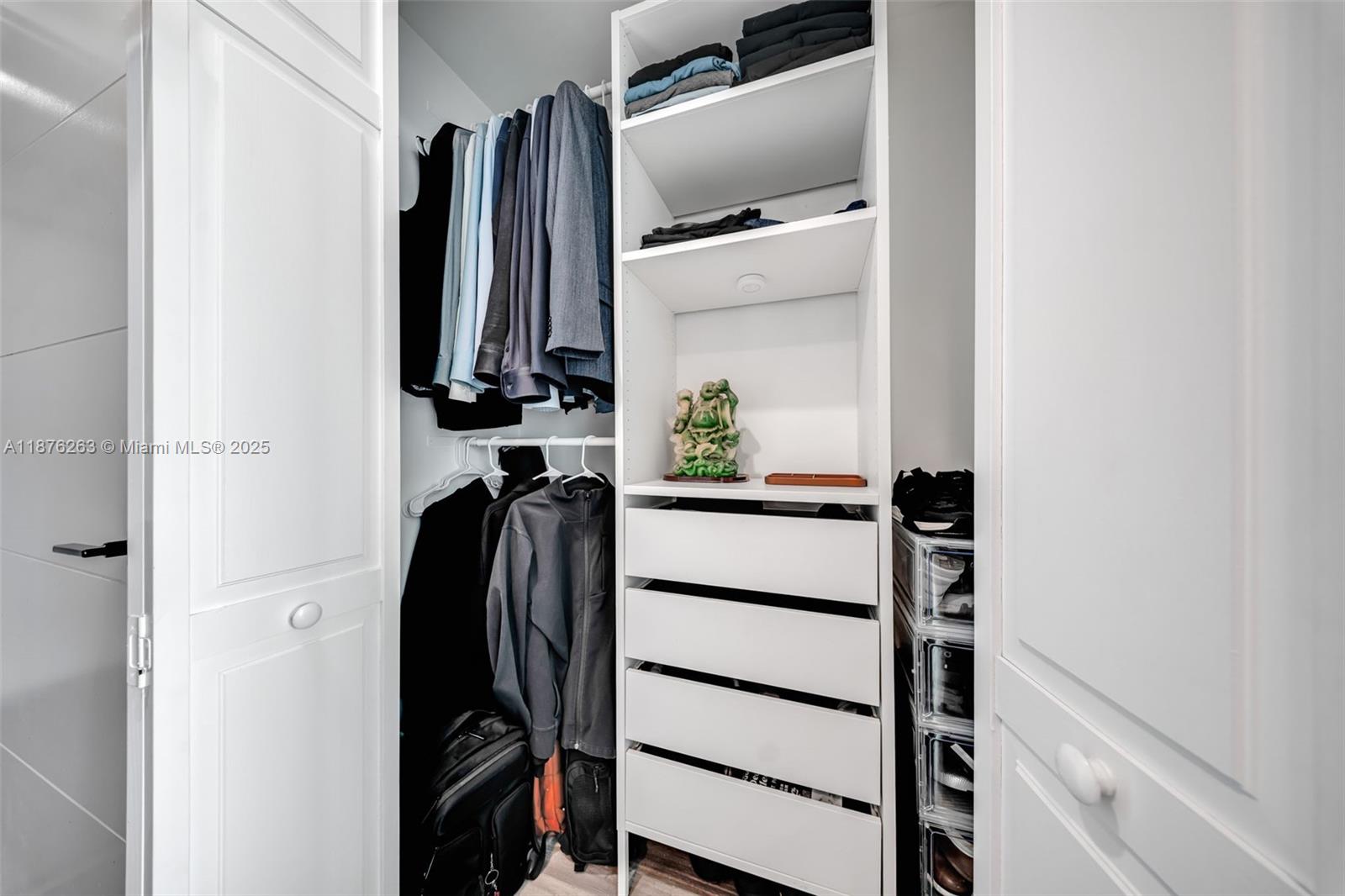 333 Northeast 24th Street, Unit 1111 Miami, FL 33137 - Photo 27 of 39 a view of walk in closet with clothes and shoes