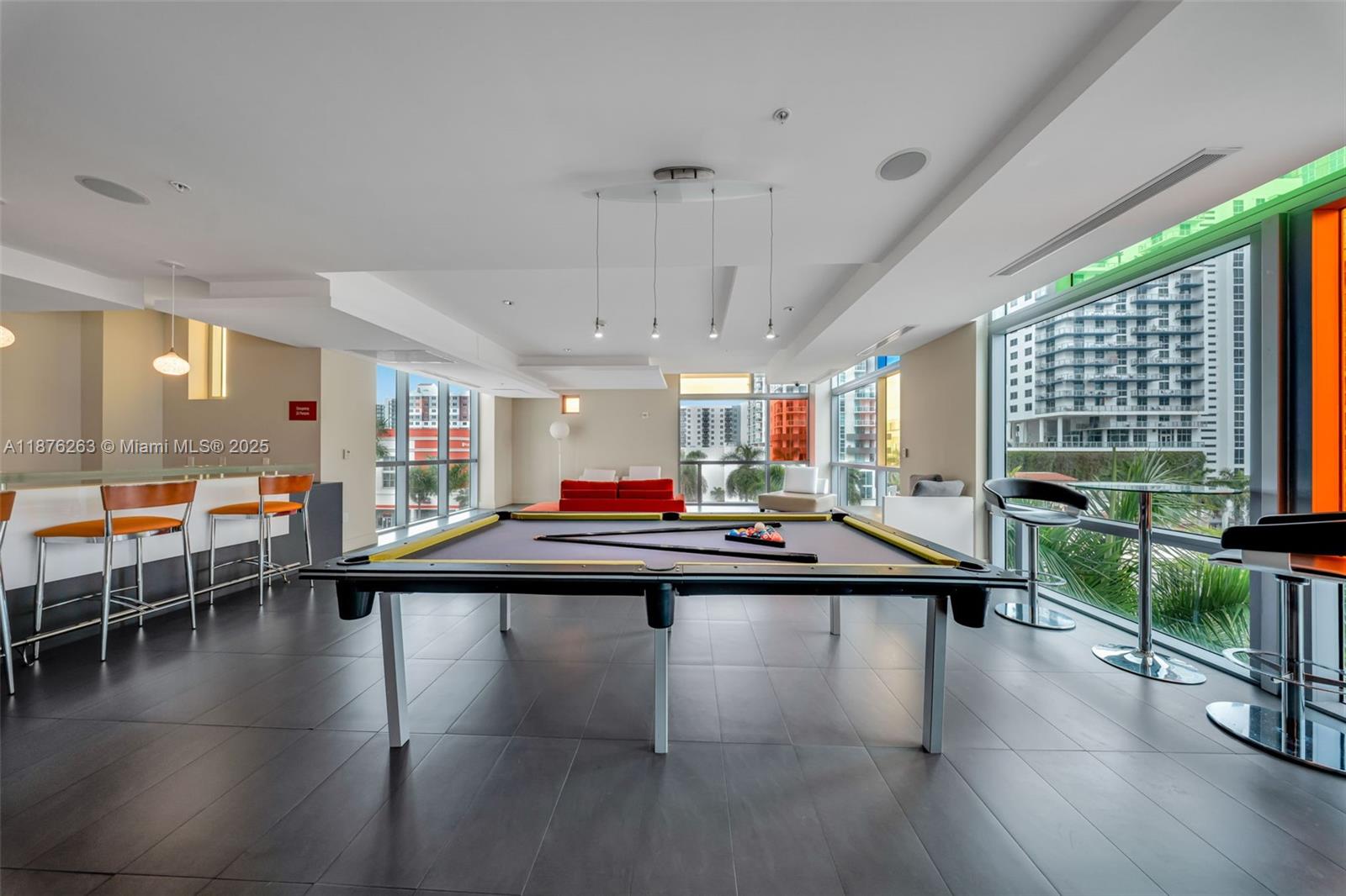 333 Northeast 24th Street, Unit 1111 Miami, FL 33137 - Photo 32 of 39 a room with lots of furniture and a wooden floor