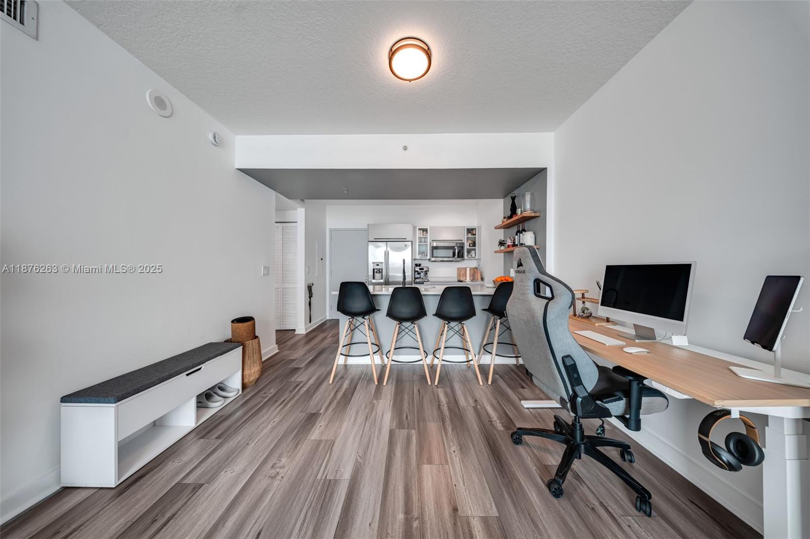 333 Northeast 24th Street, Unit 1111 Miami, FL 33137 - Photo 8 of 39 a view of a workspace with furniture and wooden floor