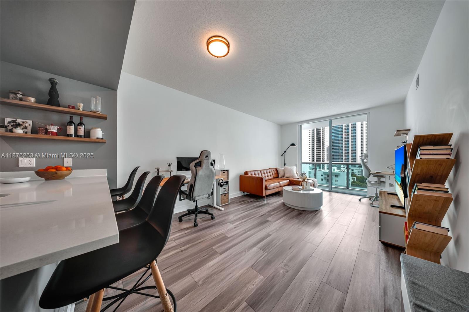 333 Northeast 24th Street, Unit 1111 Miami, FL 33137 - Photo 9 of 39 a living room with furniture and a flat screen tv