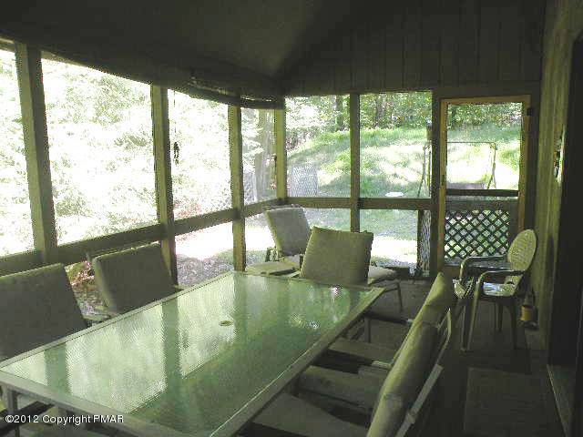 138 Elk Run Road Pocono Lake, PA 18347 - Photo 13 of 16 a view of a dining room with furniture window and outside view