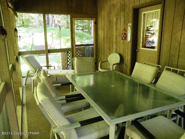 138 Elk Run Road Pocono Lake, PA 18347 - Photo 14 of 16 a living room with pool table and large windows