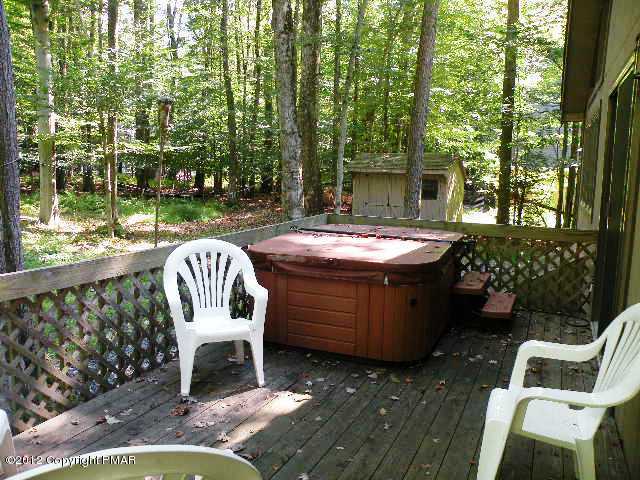 138 Elk Run Road Pocono Lake, PA 18347 - Photo 15 of 16 a view of a chair and table in backyard of the house