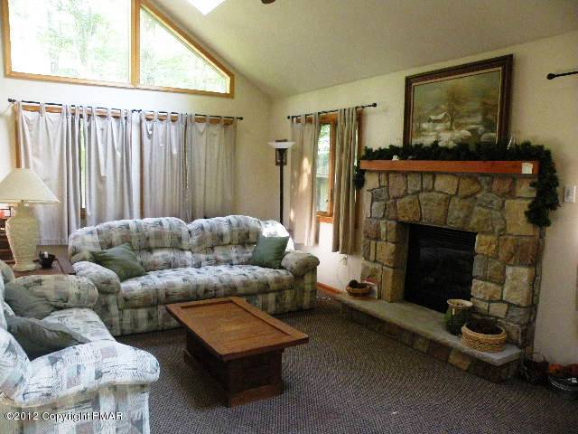 138 Elk Run Road Pocono Lake, PA 18347 - Photo 3 of 16 a living room with furniture and a fireplace