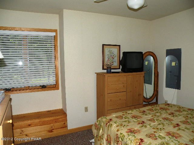 138 Elk Run Road Pocono Lake, PA 18347 - Photo 8 of 16 a bedroom with a bed and dresser