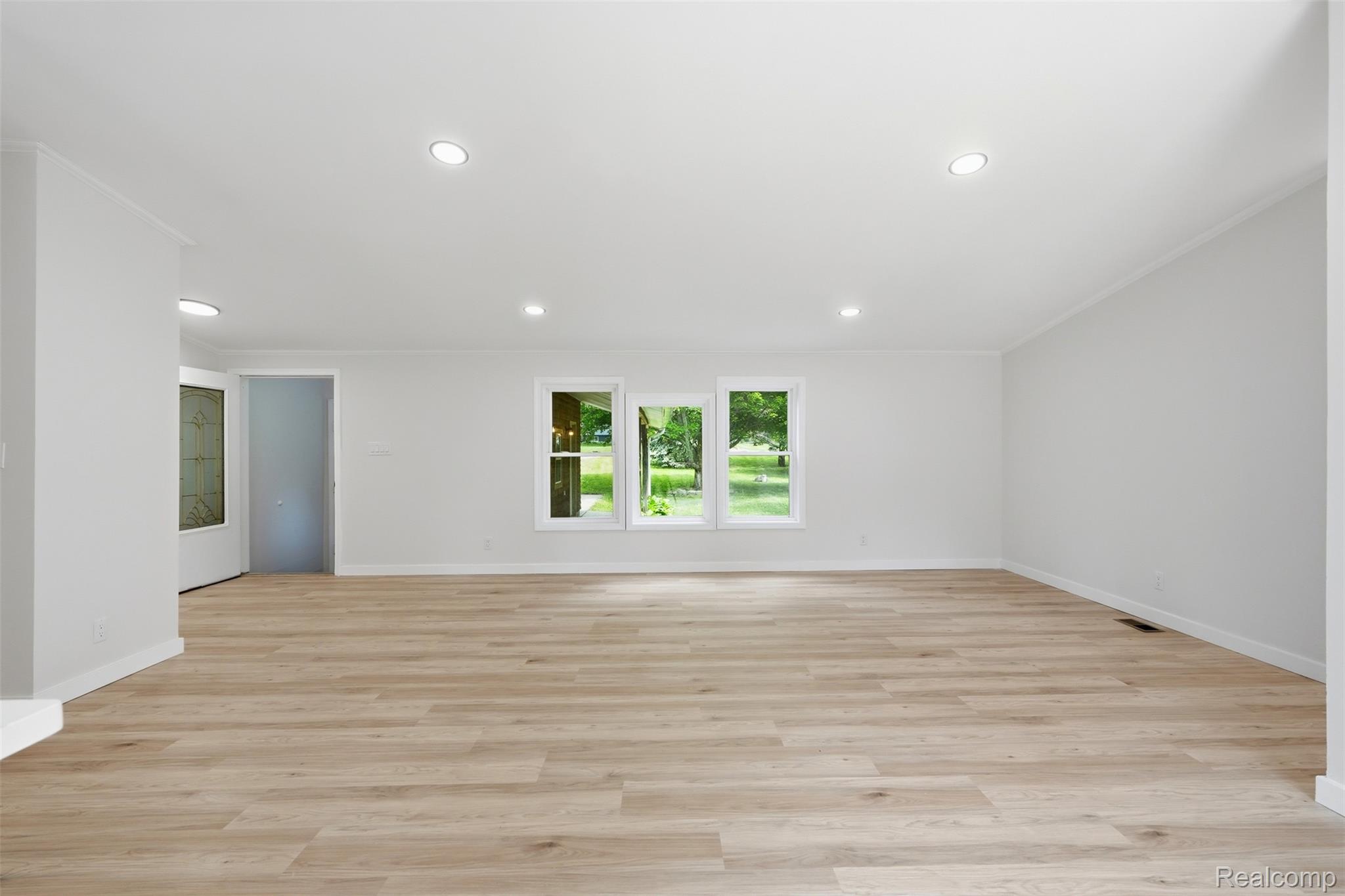 4420 Dublin Road Burton, MI 48529 - Photo 6 of 56 Spacious room featuring wood-finish flooring, white walls, and recessed lighting