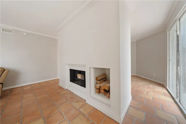 a spacious bedroom with a bed and a chandelier
