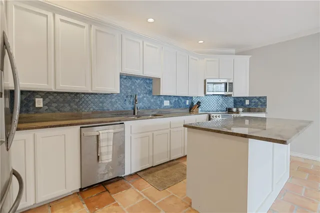 a view of kitchen with furniture and refrigerator