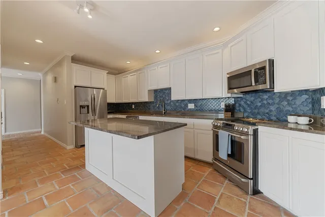 a bedroom with a bed a mirror and a window