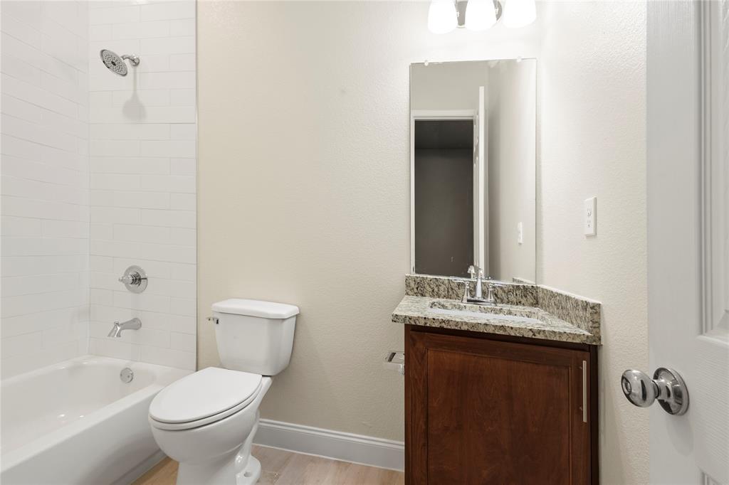 503 South 5th Street Bonham, TX 75418 - Photo 11 of 22 a bathroom with a granite countertop sink toilet and shower
