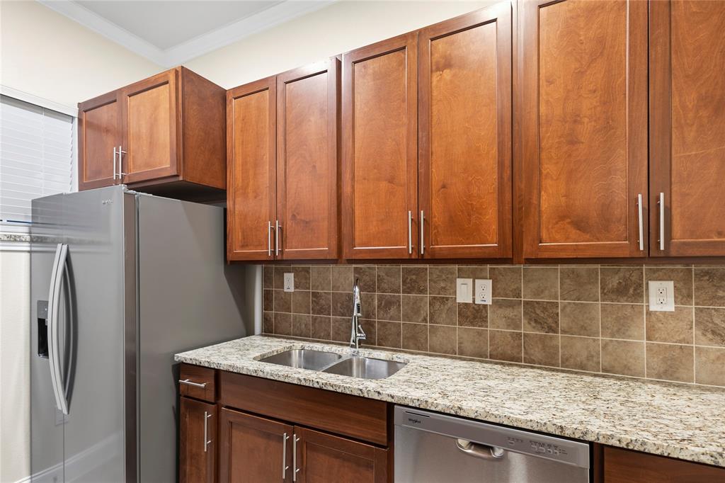 503 South 5th Street Bonham, TX 75418 - Photo 7 of 22 a kitchen with stainless steel appliances granite countertop a refrigerator and a sink