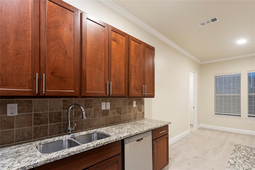 503 South 5th Street Bonham, TX 75418 - Photo 8 of 22 a kitchen with granite countertop a sink a stove and cabinets