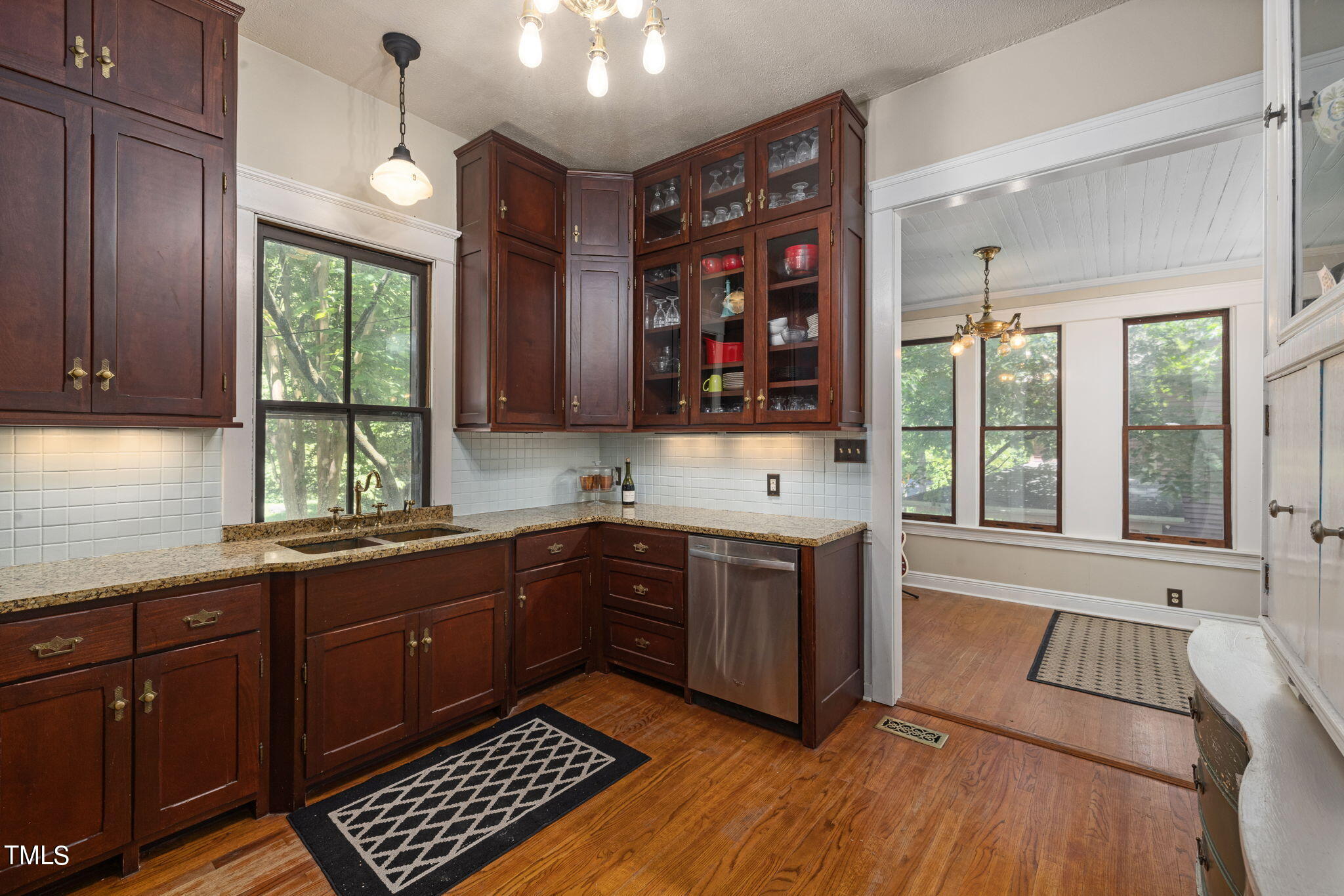 601 East Lane Street Raleigh, NC 27601 - Photo 13 of 34 a kitchen with stainless steel appliances granite countertop wooden cabinets a stove a sink and a window