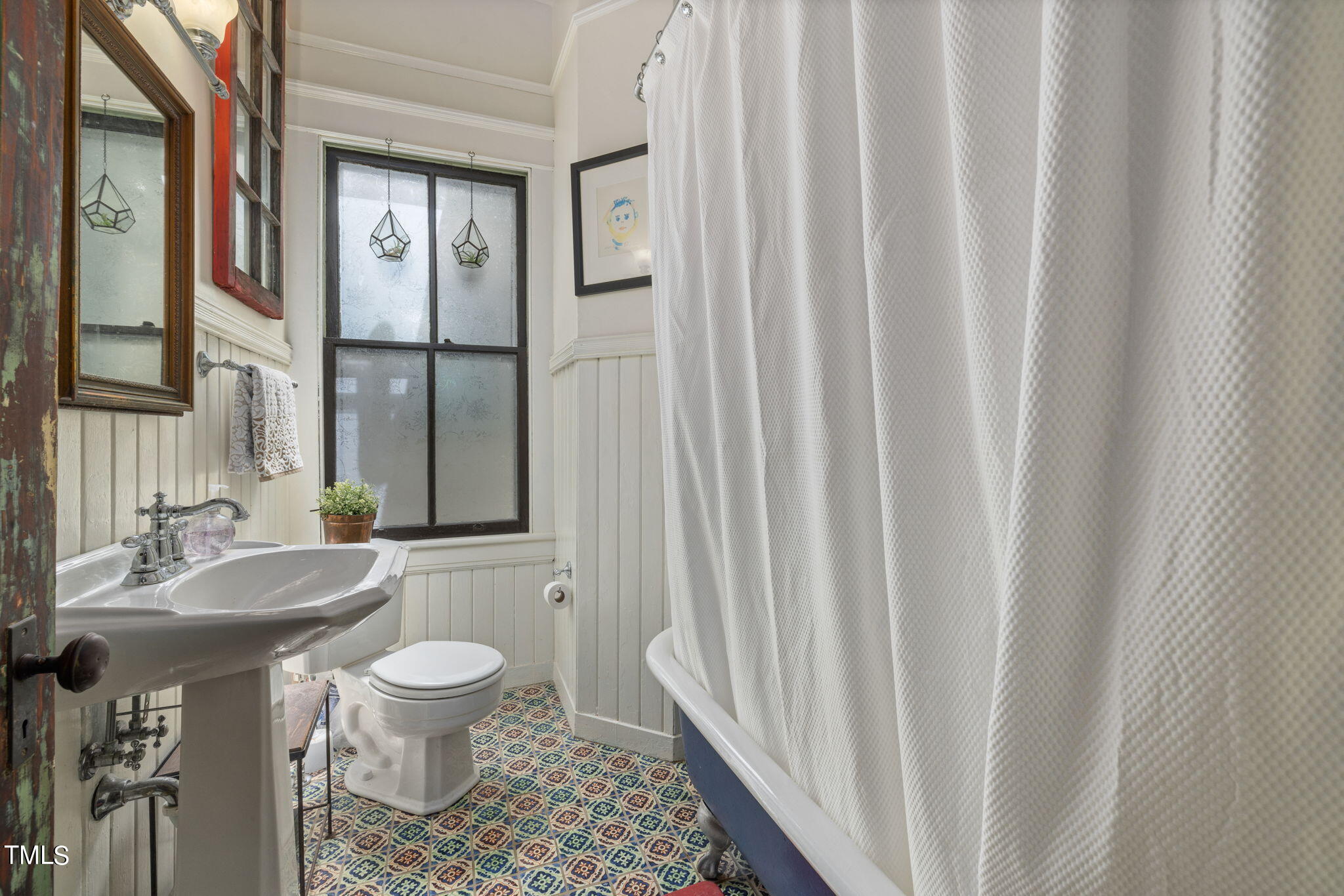 601 East Lane Street Raleigh, NC 27601 - Photo 18 of 34 a bathroom with a sink a toilet a mirror and shower