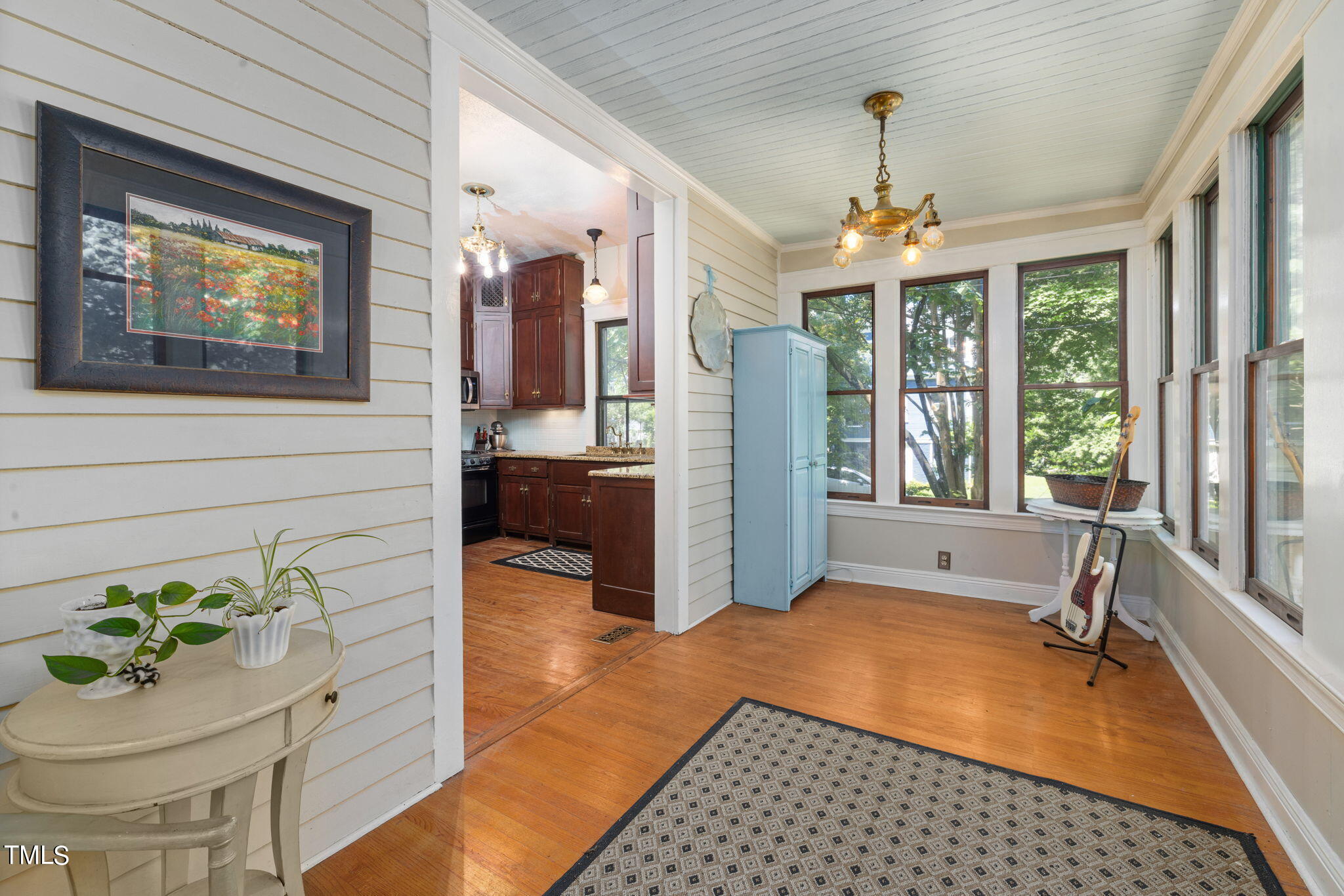 601 East Lane Street Raleigh, NC 27601 - Photo 19 of 34 a spacious bedroom with a bed and a chandelier