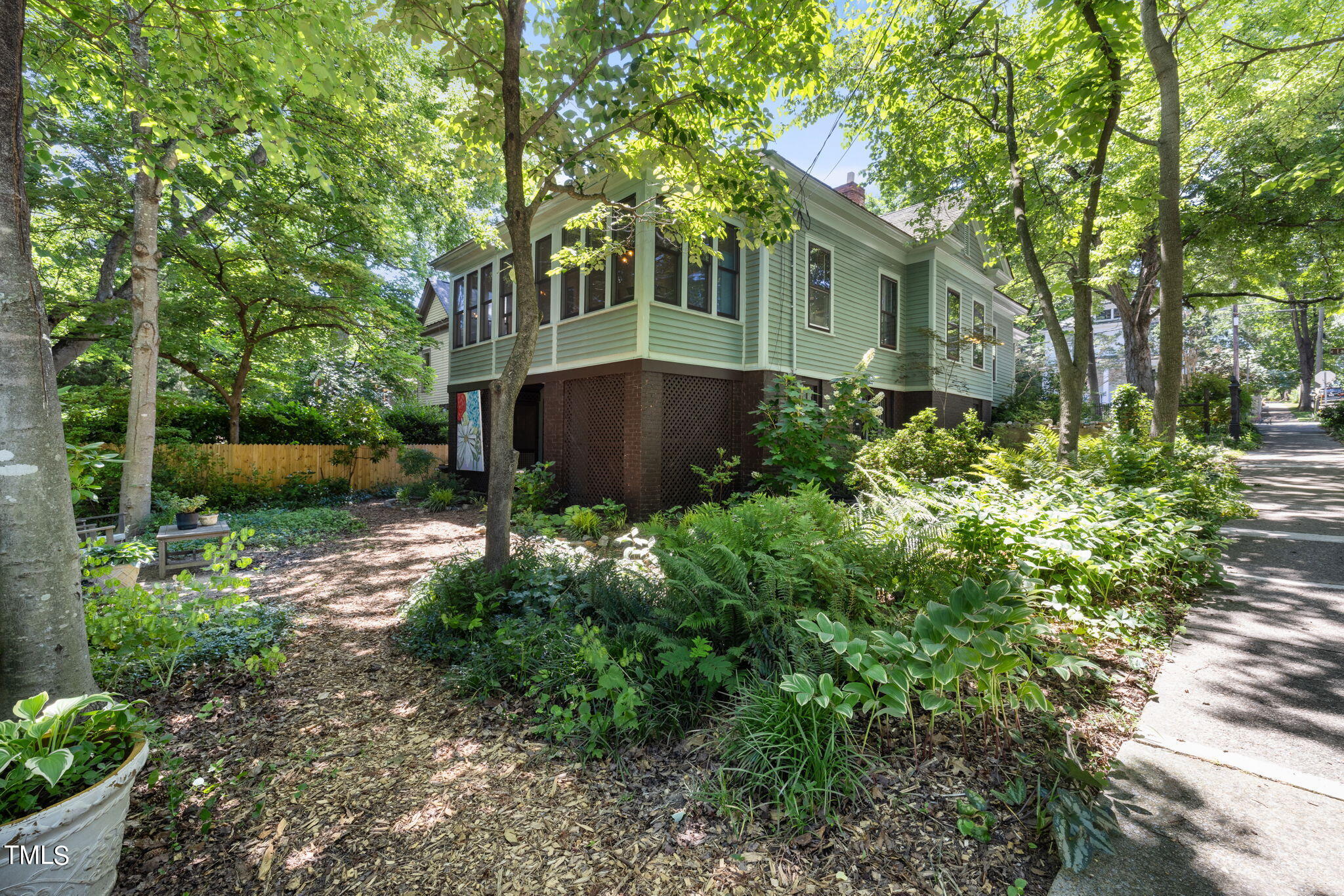 601 East Lane Street Raleigh, NC 27601 - Photo 32 of 34 a view of backyard with potted plants and large trees