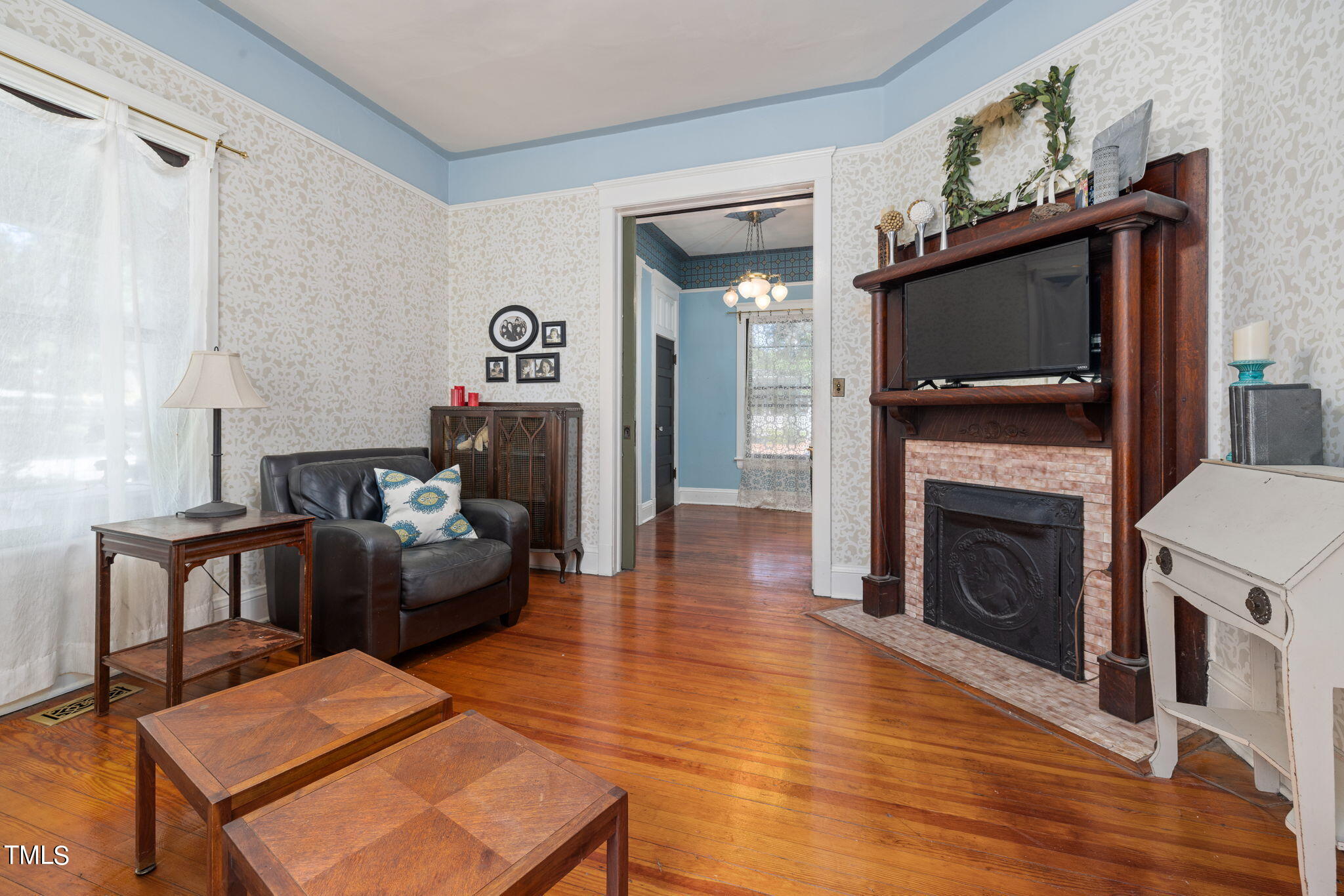 601 East Lane Street Raleigh, NC 27601 - Photo 6 of 34 a living room with furniture a flat screen tv and a fireplace