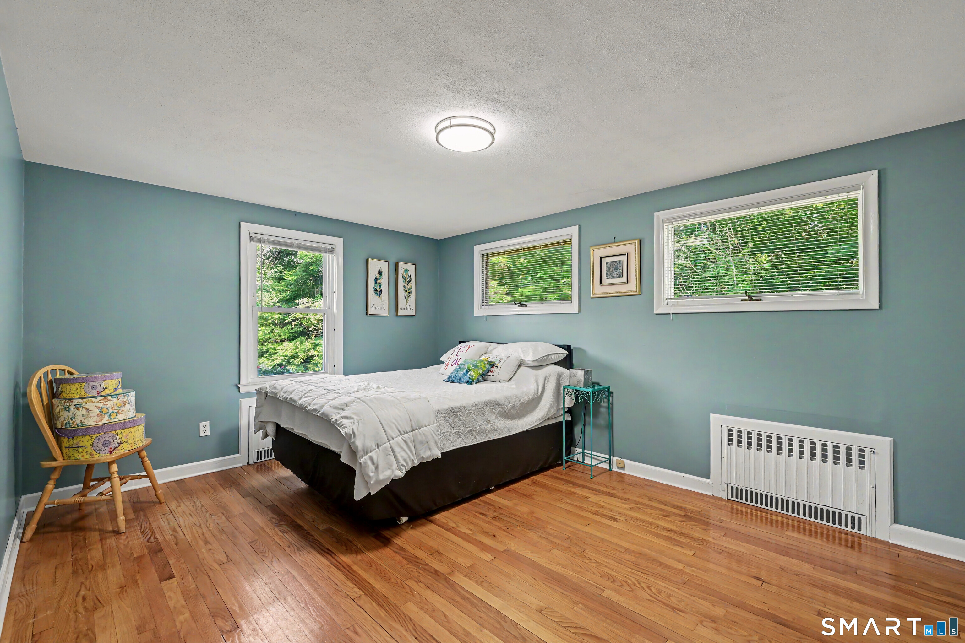 524 Ferry Road Orange, CT 06477 - Photo 28 of 40 a bedroom with a bed a table and chair