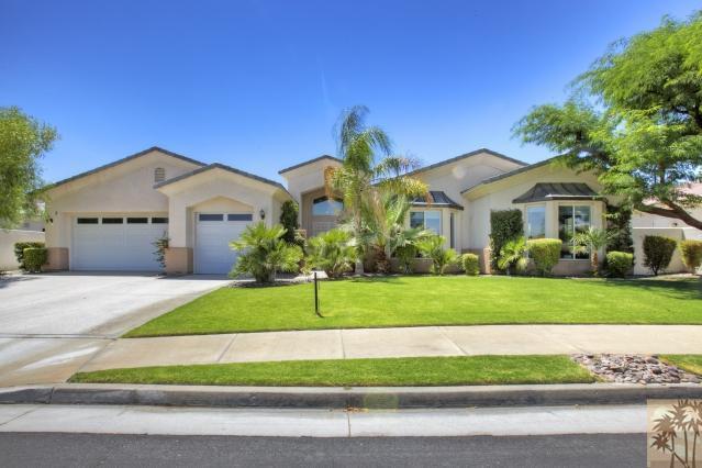 a front view of a house with a garden and yard