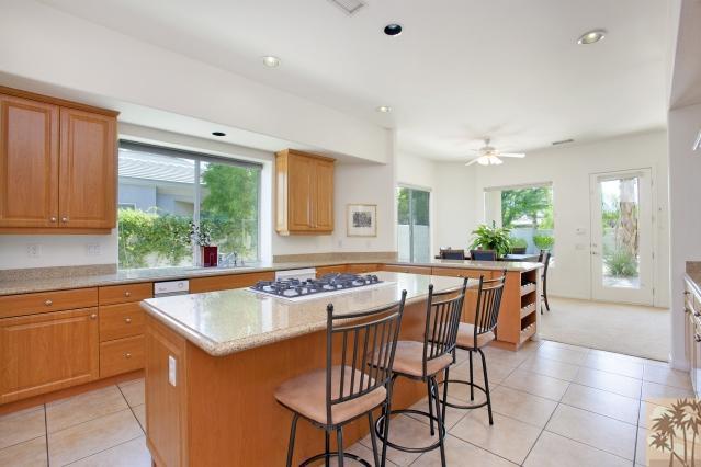 5 Champagne Circle Rancho Mirage, CA 92270 - Photo 12 of 24 a kitchen with a table chairs and window