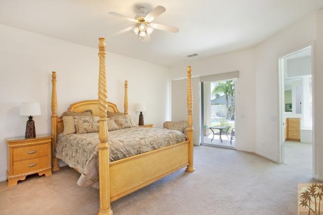 5 Champagne Circle Rancho Mirage, CA 92270 - Photo 14 of 24 a bedroom with a bed and ceiling fan