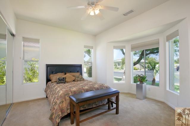 5 Champagne Circle Rancho Mirage, CA 92270 - Photo 18 of 24 a bedroom with a large bed and a window
