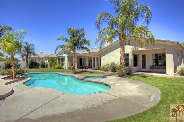 5 Champagne Circle Rancho Mirage, CA 92270 - Photo 19 of 24 a view of a house with swimming pool and a yard