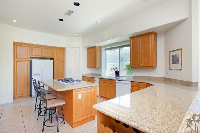5 Champagne Circle Rancho Mirage, CA 92270 - Photo 10 of 24 a kitchen with granite countertop kitchen island stainless steel appliances a sink table and chairs