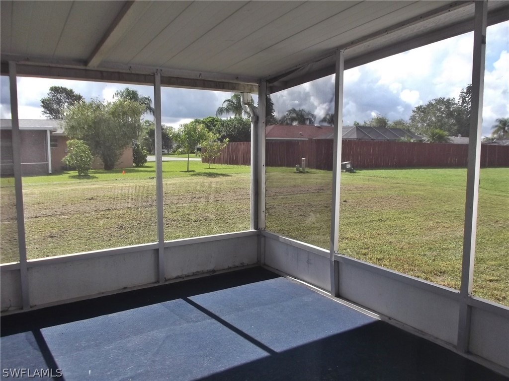 108 Rowland Road Lehigh Acres, FL 33936 - Photo 3 of 8 a view of a room with porch and a big yard