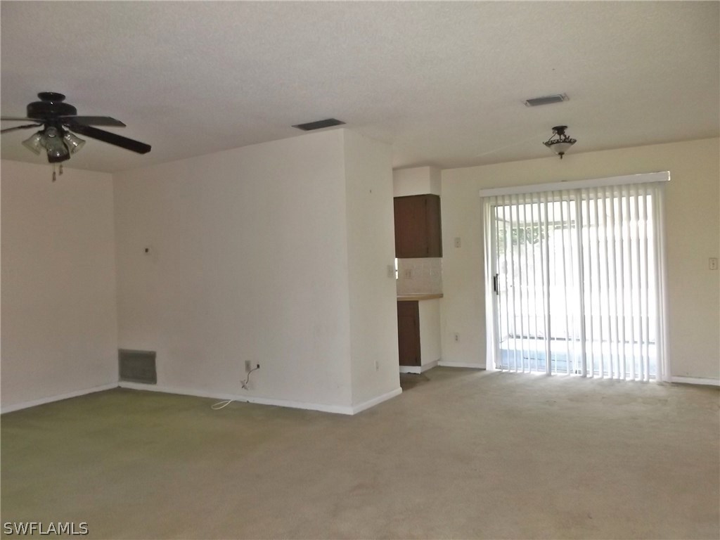 108 Rowland Road Lehigh Acres, FL 33936 - Photo 5 of 8 a view of a livingroom with a staircase