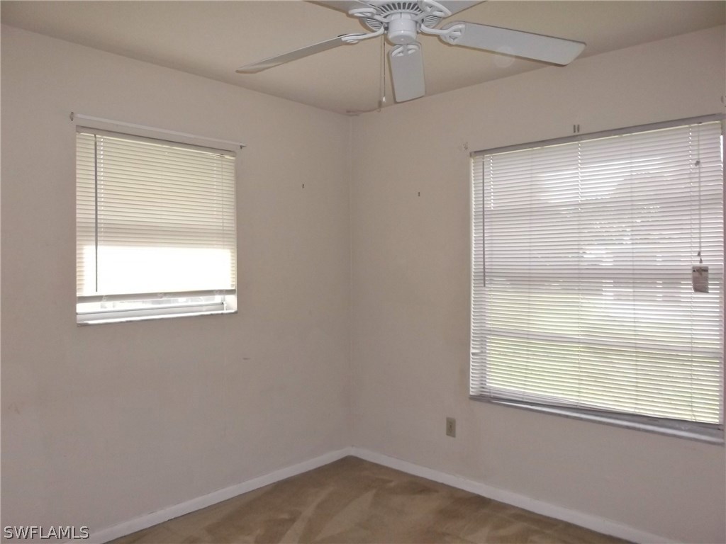 108 Rowland Road Lehigh Acres, FL 33936 - Photo 7 of 8 a view of an empty room with a window