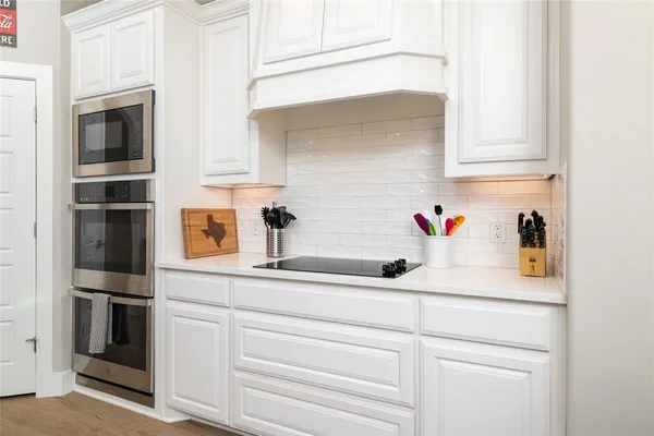 a kitchen with stainless steel appliances a sink and cabinets