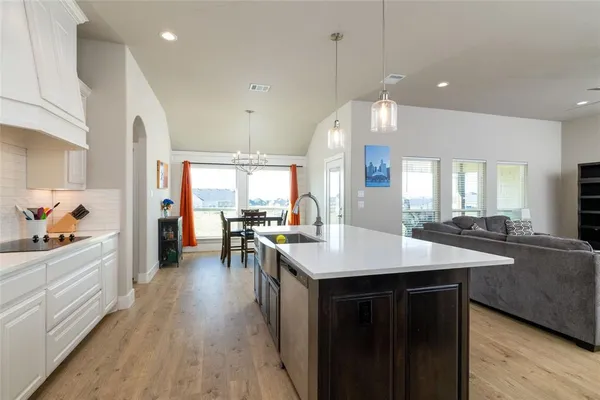 a kitchen with counter space sink stove and wooden floor