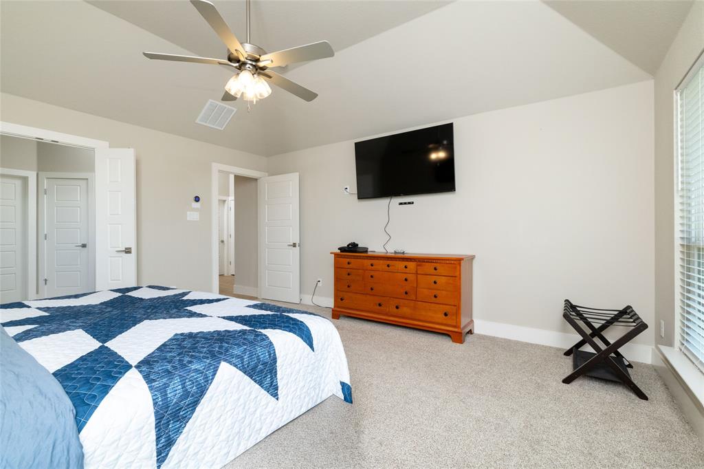321 Monument Pl. Azle, TX 76020 - Photo 20 of 38 a bedroom with a bed and a flat screen tv