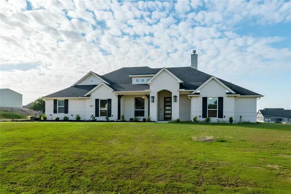 a front view of a house with a yard