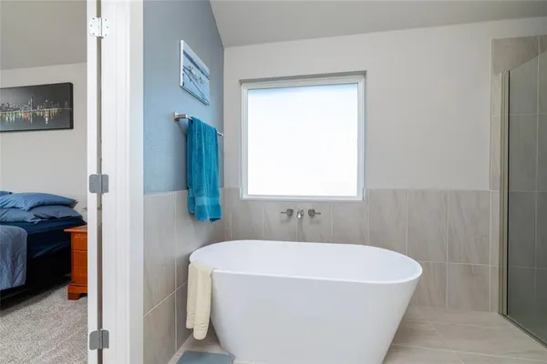 a bathroom with a bathtub and a shower