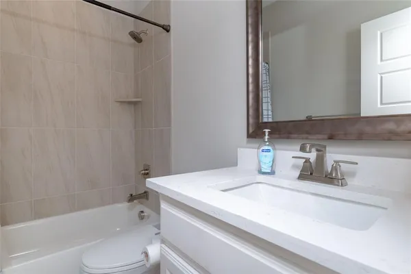 a bathroom with a sink a toilet and a bathtub