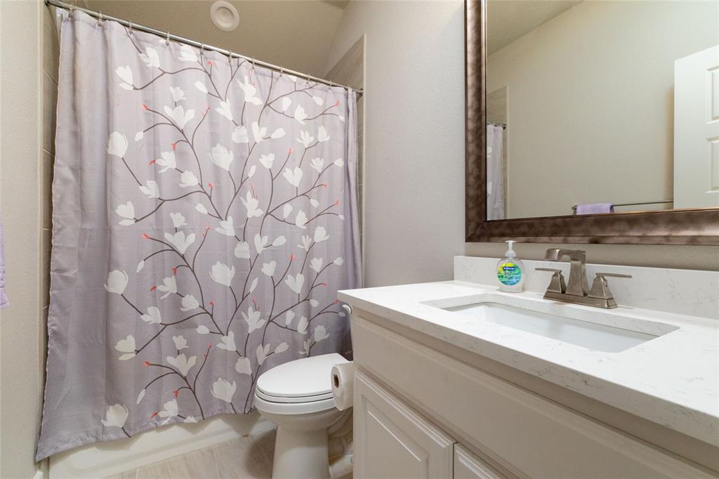 321 Monument Pl. Azle, TX 76020 - Photo 25 of 37 Full bathroom featuring vanity and shower / bath combo with shower curtain