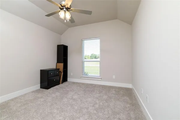 an empty room with closet and a chandelier fan