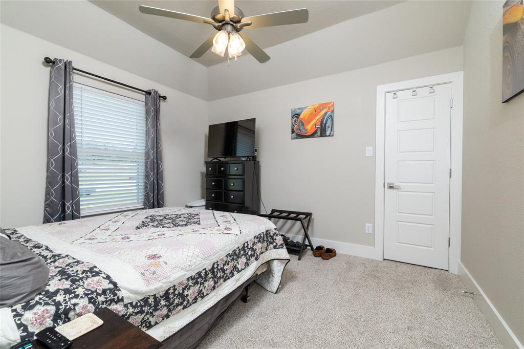 321 Monument Pl. Azle, TX 76020 - Photo 29 of 38 a bedroom with a bed and a flat screen tv