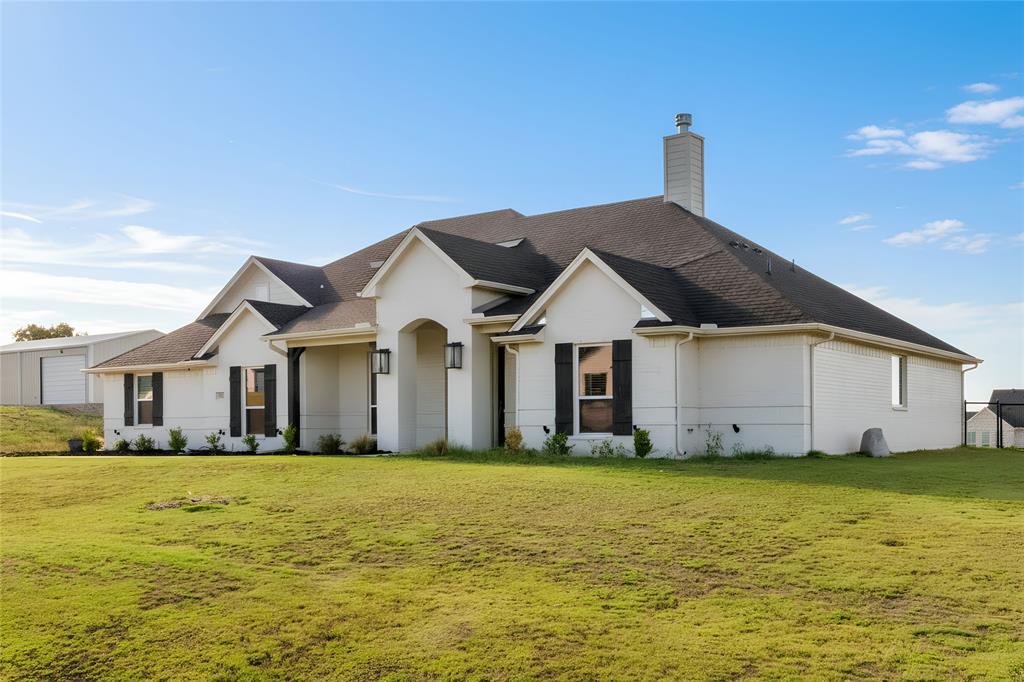 321 Monument Pl. Azle, TX 76020 - Photo 3 of 37 View of front of house with a front yard, roof with shingles, and a chimney