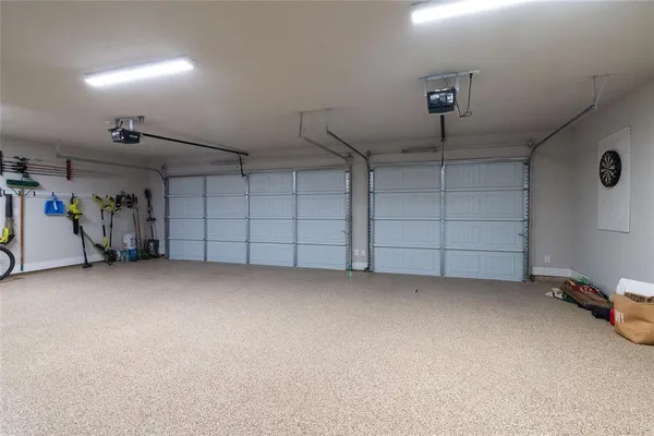 an empty room with a cabinet and mirrors