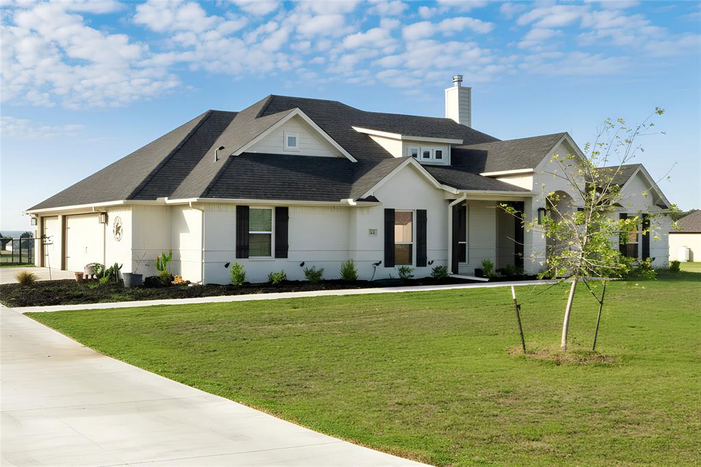 321 Monument Pl. Azle, TX 76020 - Photo 4 of 37 View of front of home with roof with shingles, a chimney, and a front lawn