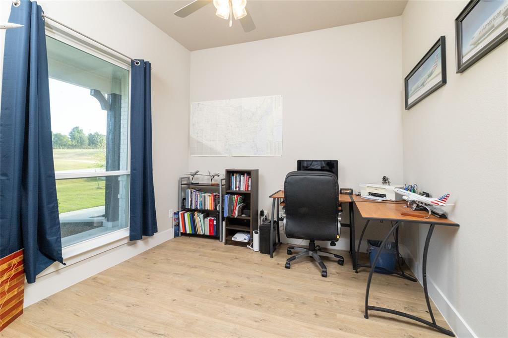 321 Monument Pl. Azle, TX 76020 - Photo 5 of 38 a view of a workspace with furniture and a window
