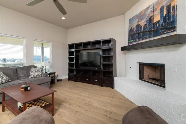a living room with furniture a flat screen tv and a fireplace