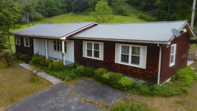 a aerial view of a house with yard and green space